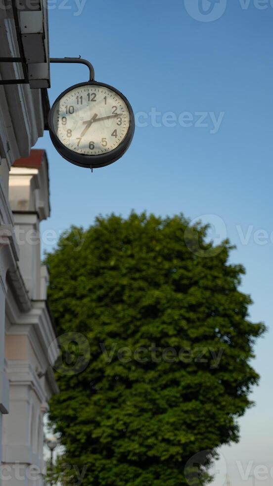 Street clock, on the building of the railway station photo