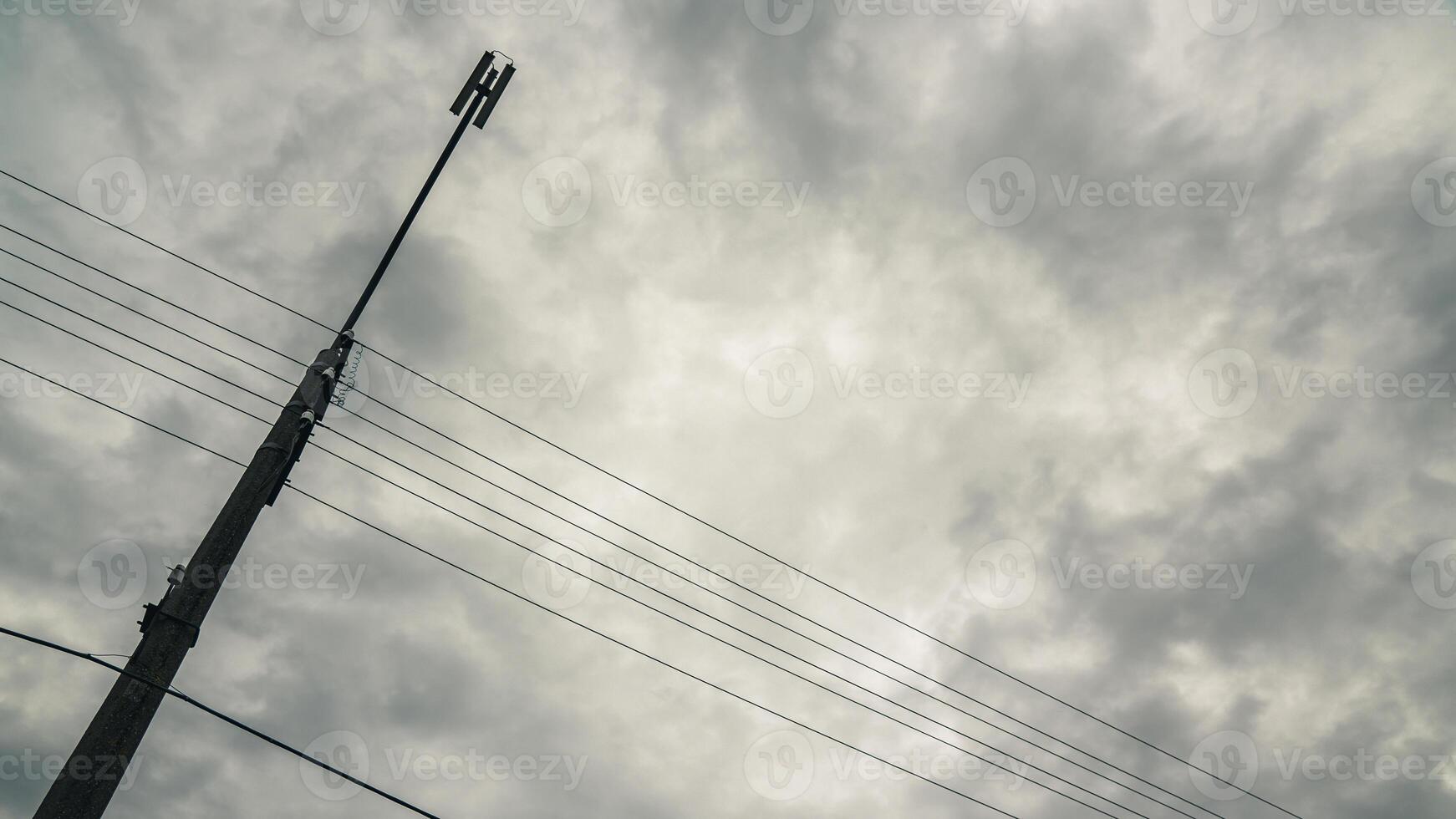 Support of a street lamp with a view of the cloudy sky photo