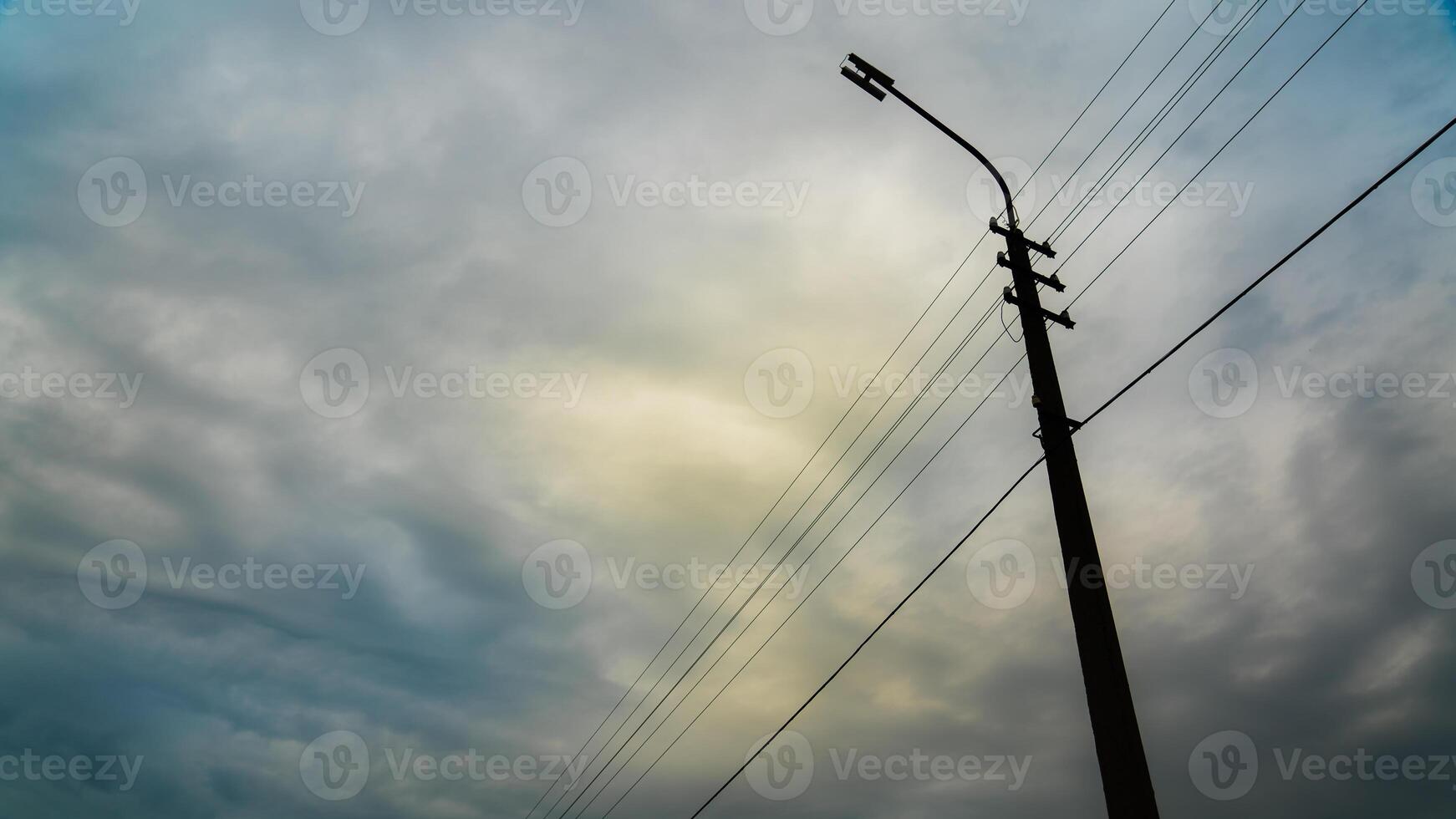 street lamp with a view of the cloudy sky photo