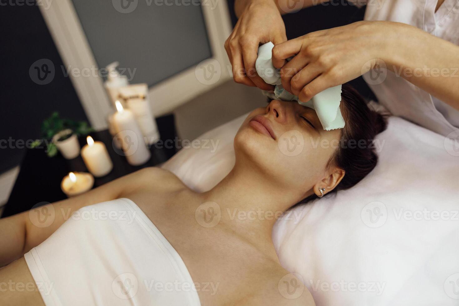 Beautician Applying Alginate Mask On Female Face With Smooth Soft Skin photo
