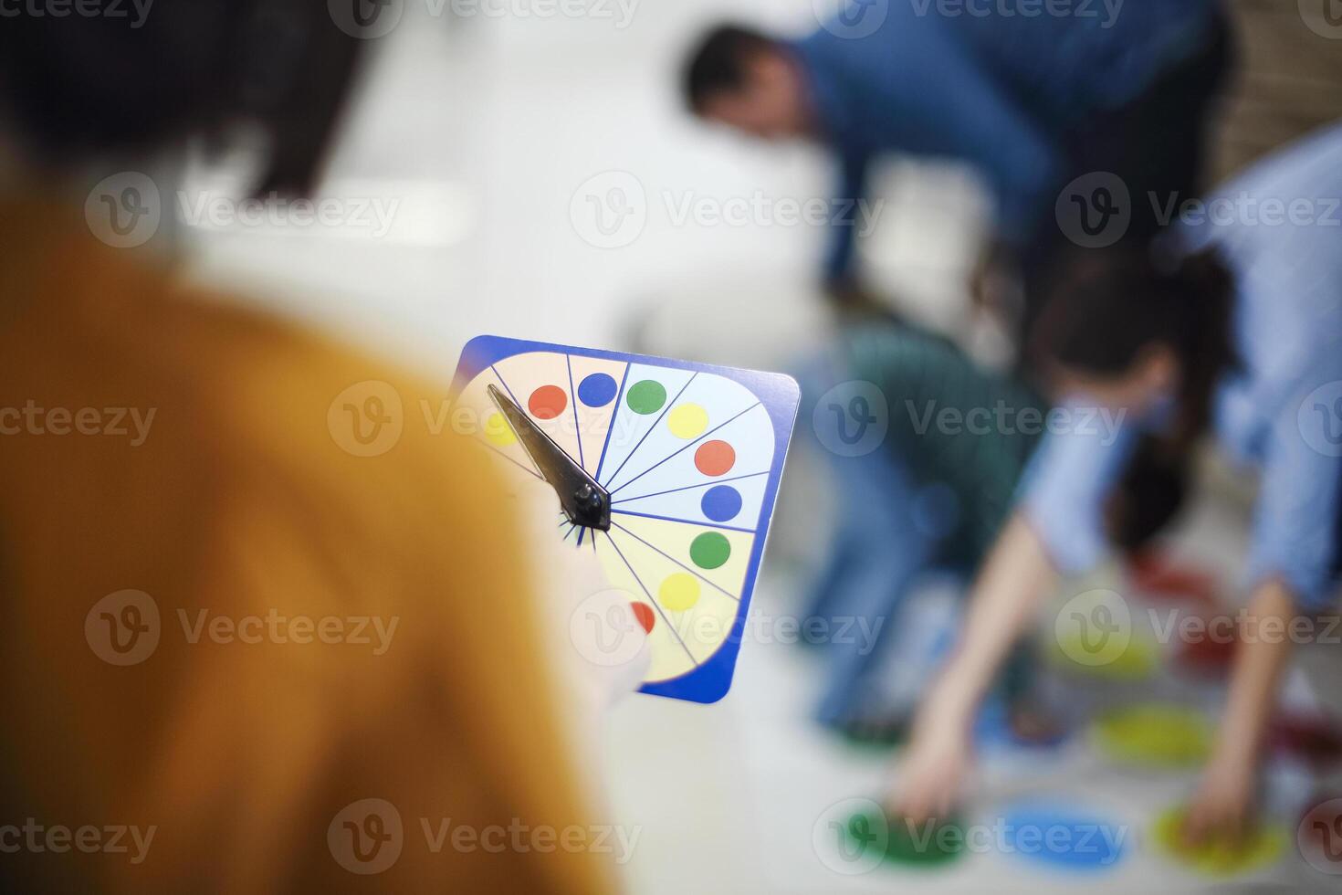 kids with father and mother playing twister game at home. Family activity photo