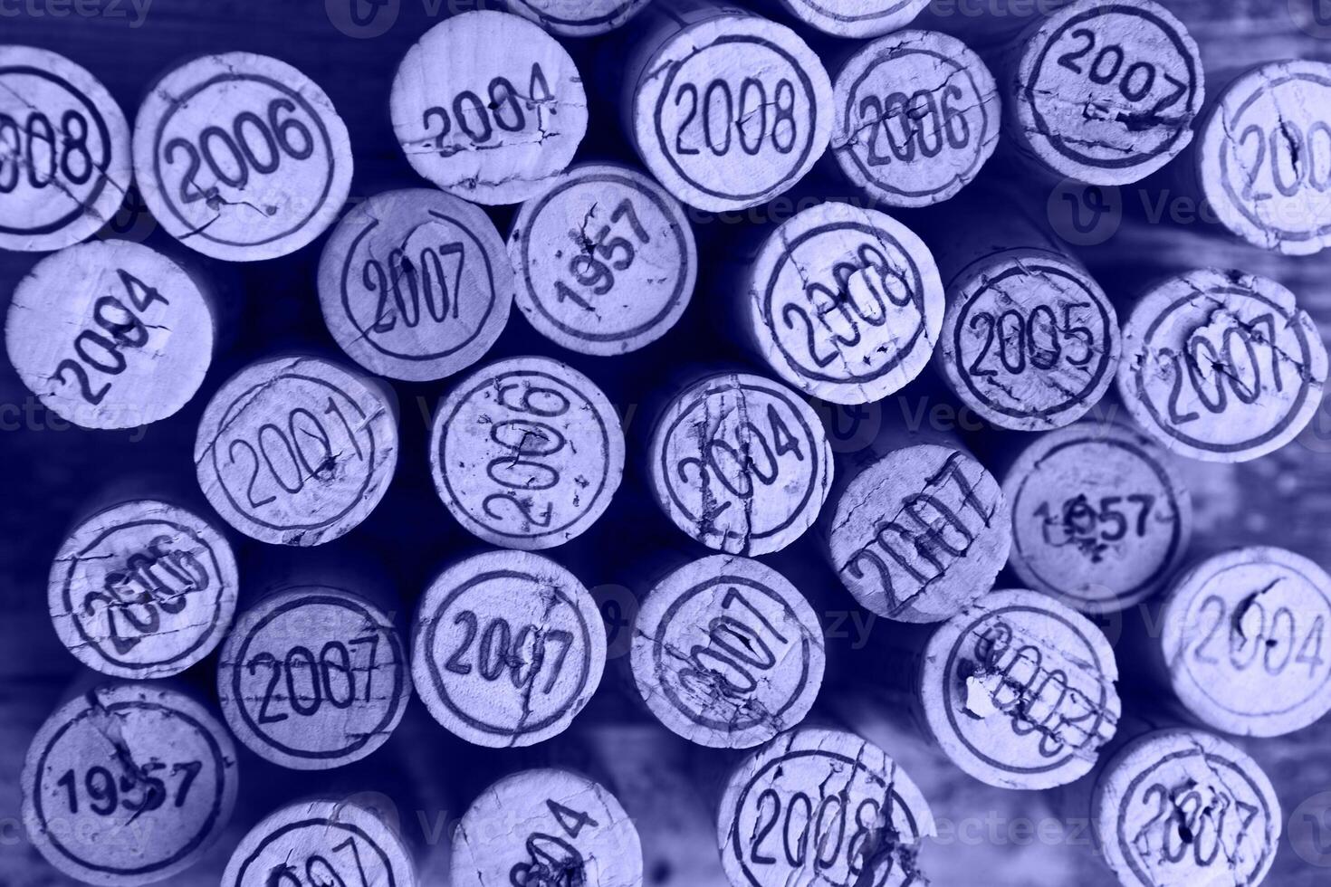 Dated wine bottle corks on the wooden background photo