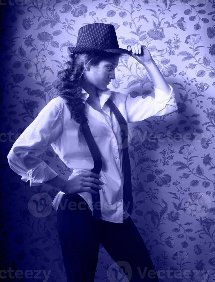 Portrait of the beautiful stylish brunette girl in hat photo