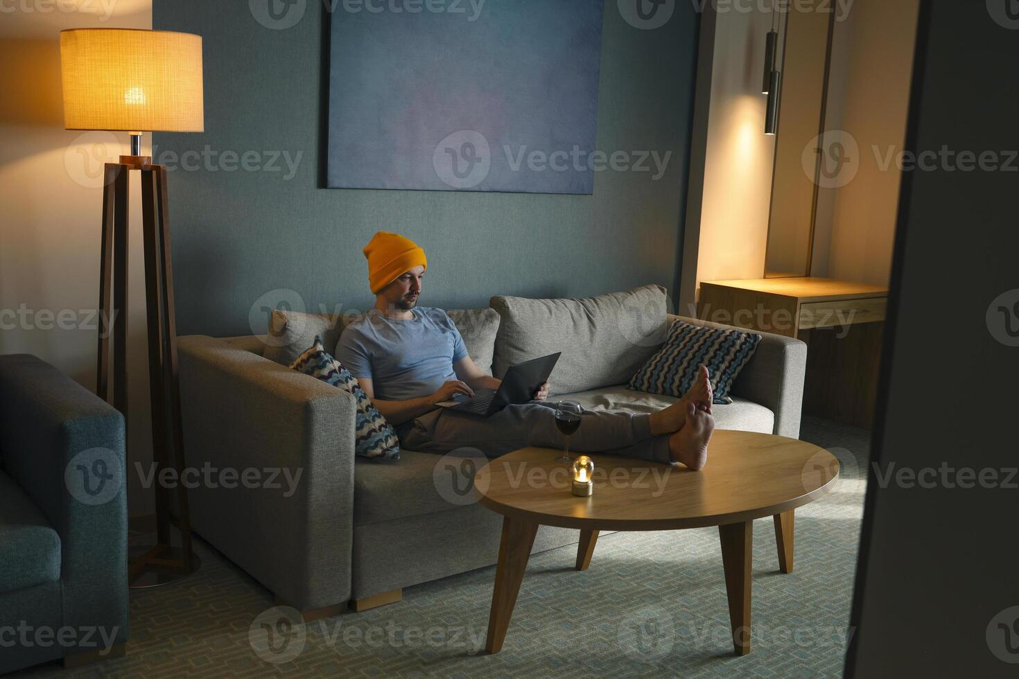 Male freelancer works at computer or communicates on link photo