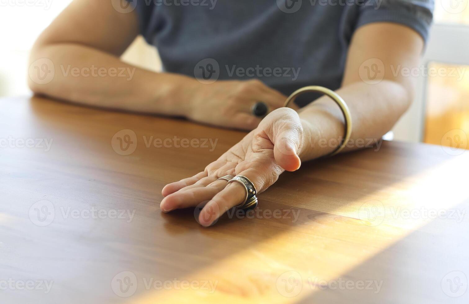 Mature woman showing her palm with life lines to chiromancer or palmist. Palmistry and chiromancy photo