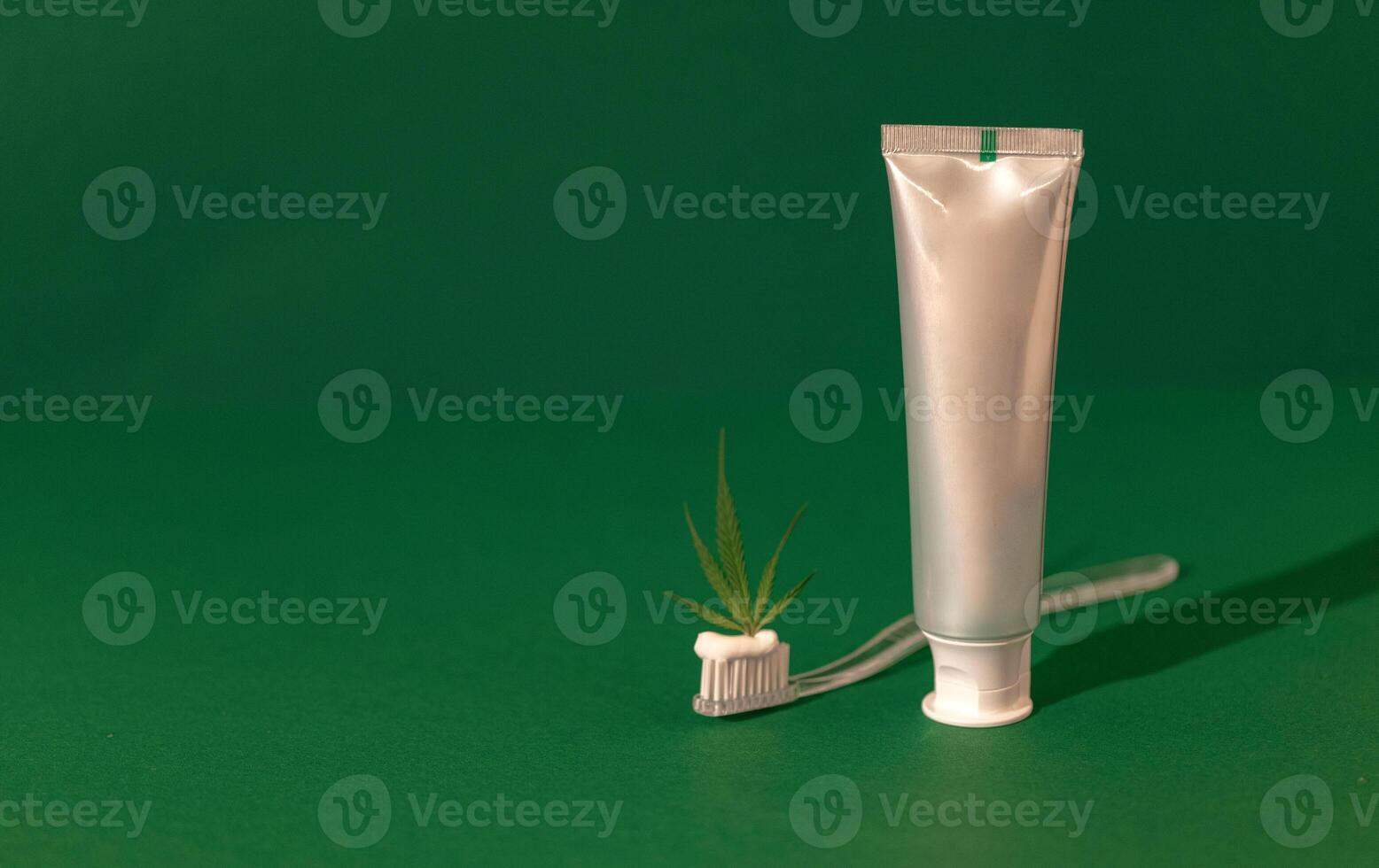 A transparent plastic toothbrush with white Cannabis CBD toothpaste photo