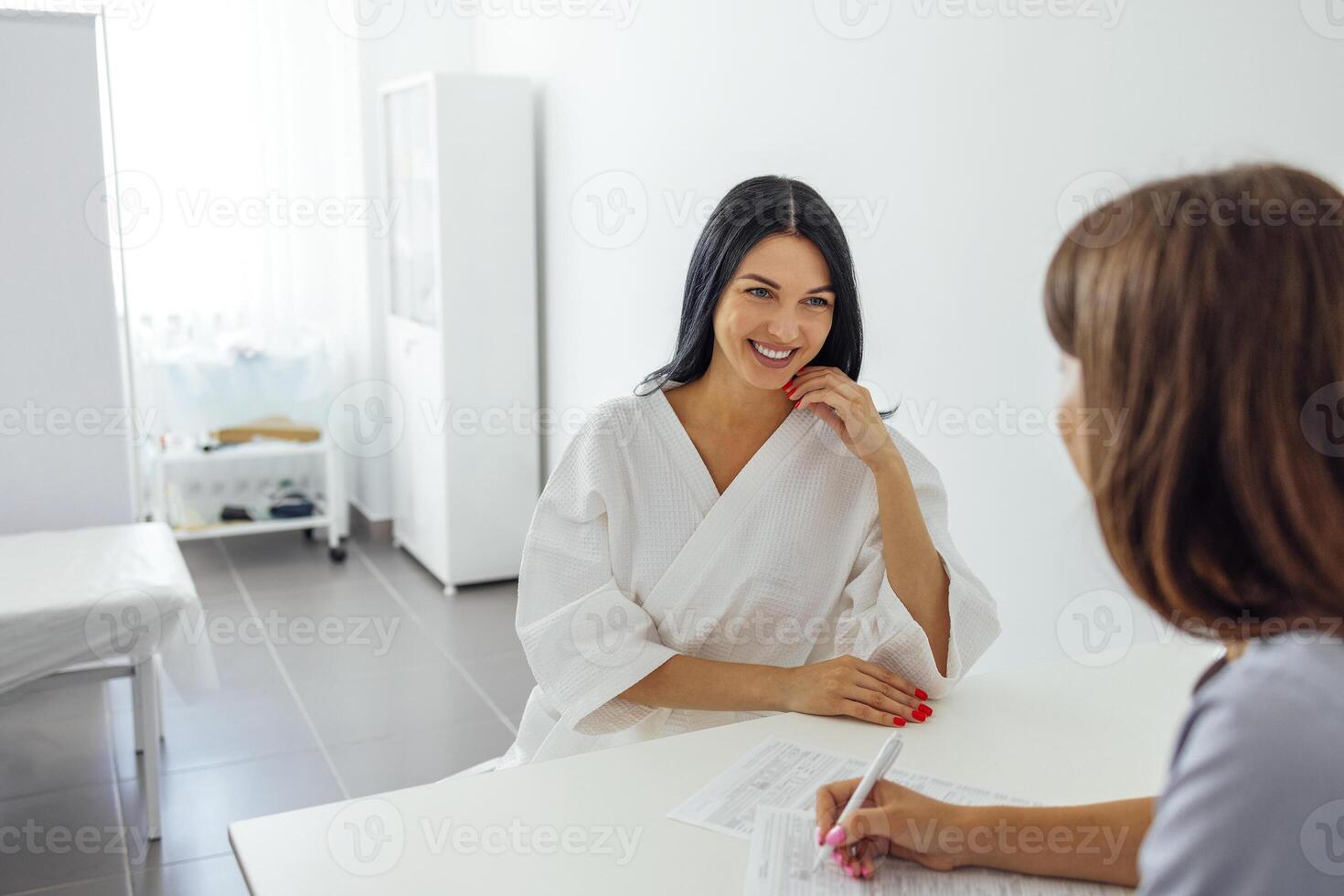 Beautician or doctor records information about the client or patient photo