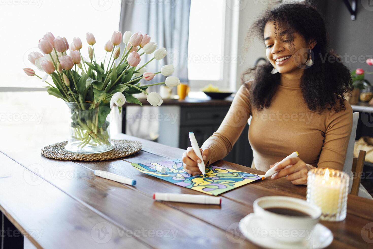 Young brunette african american woman creating her neurographics wish map using colorful marker photo
