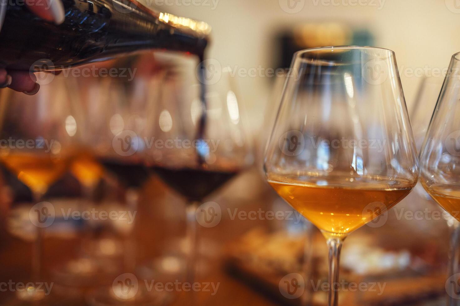 Glass goblets placed in rows on table during wine tasting procedure in restaurant photo