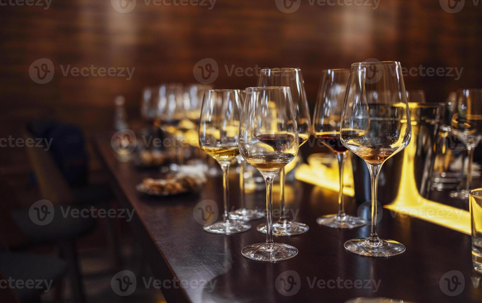 Glass goblets placed in rows on table during wine tasting procedure in restaurant photo