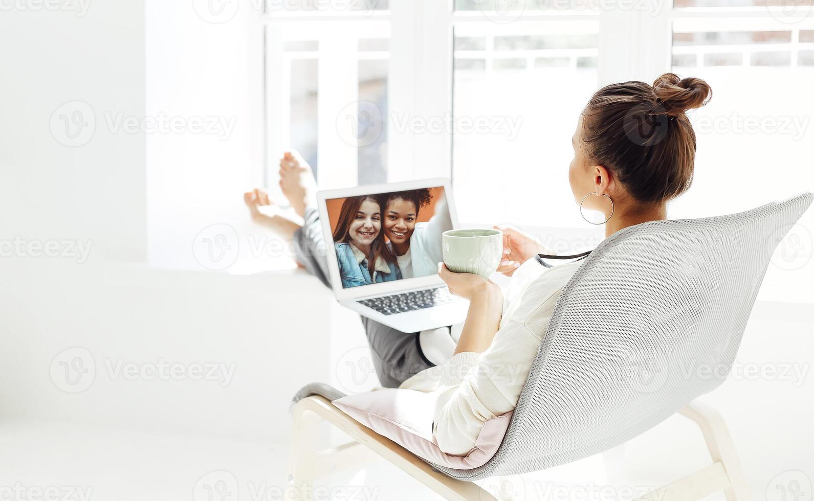 Young woman resting with laptop photo