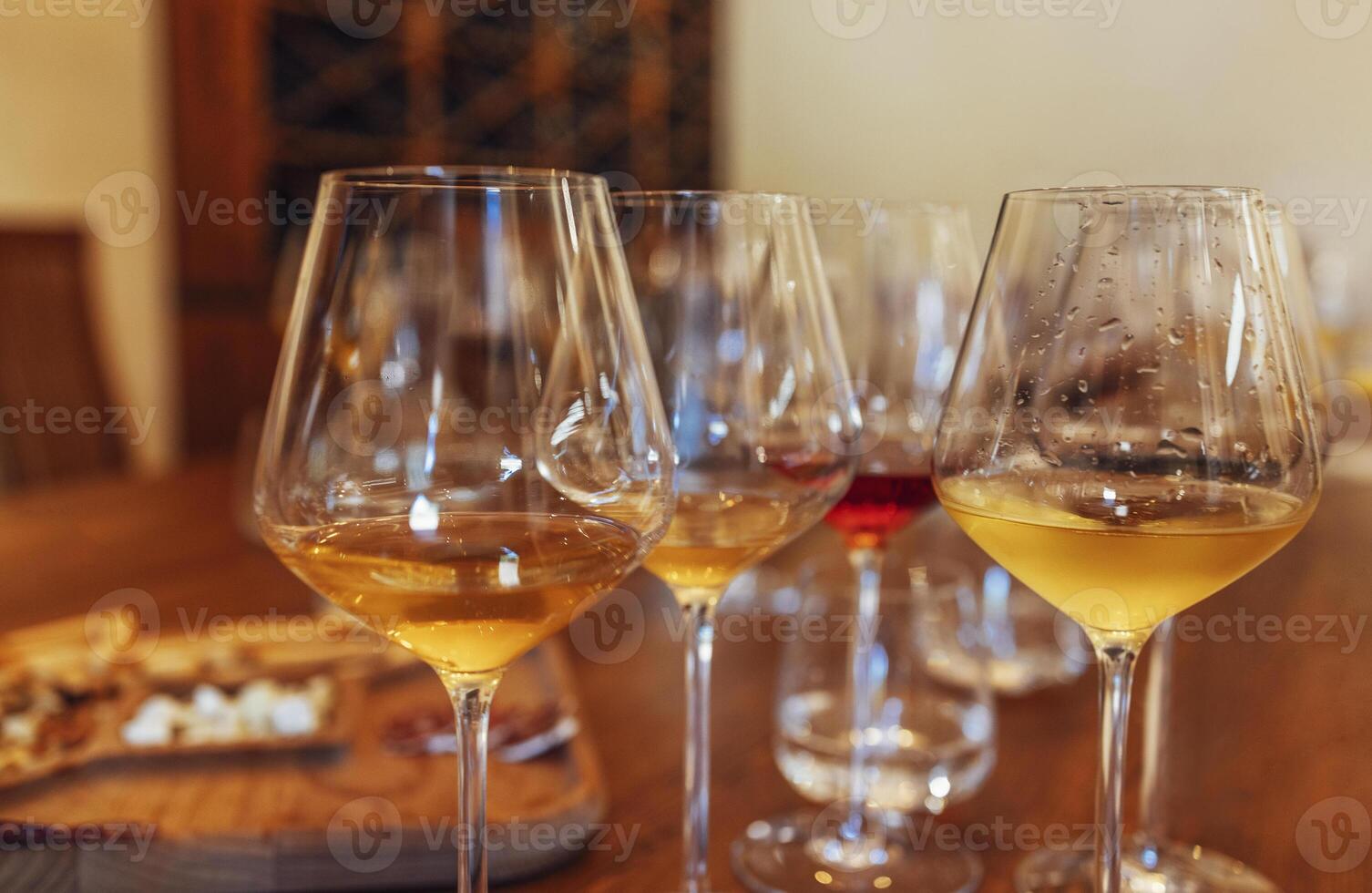 Glass goblets placed in rows on table during wine tasting procedure in restaurant photo