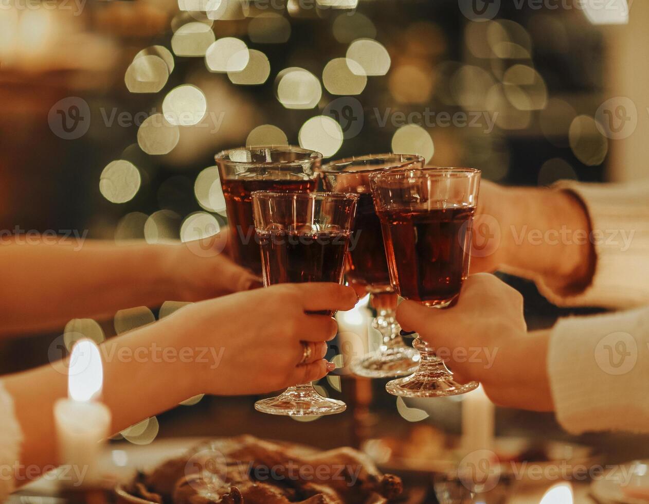 Family friends have fun together in winter eating food on a wooden table photo