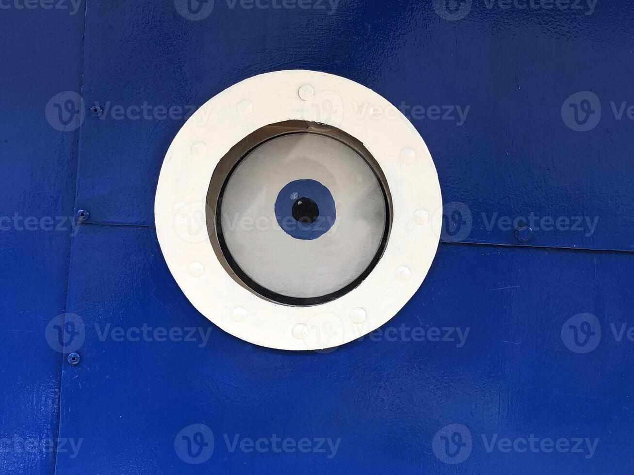 An eye in a round porthole, the concept of the all-seeing eye photo