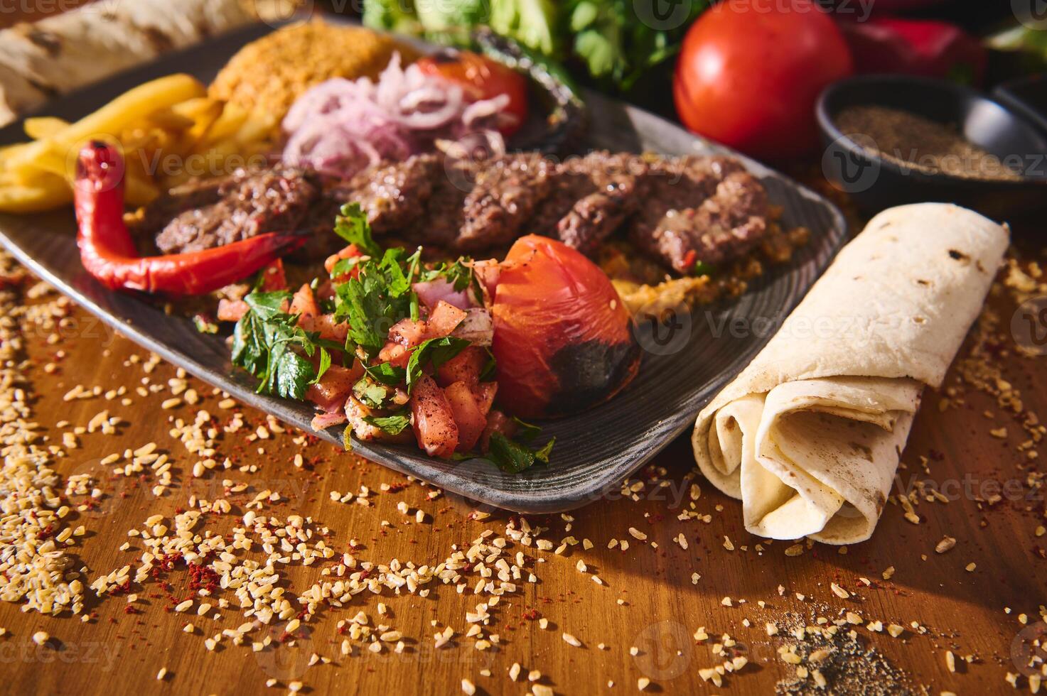 Delicious Middle Eastern food platter with grilled kebabs, fresh salad, and flatbread on a wooden table showcasing authentic flavors and vibrant presentation. photo