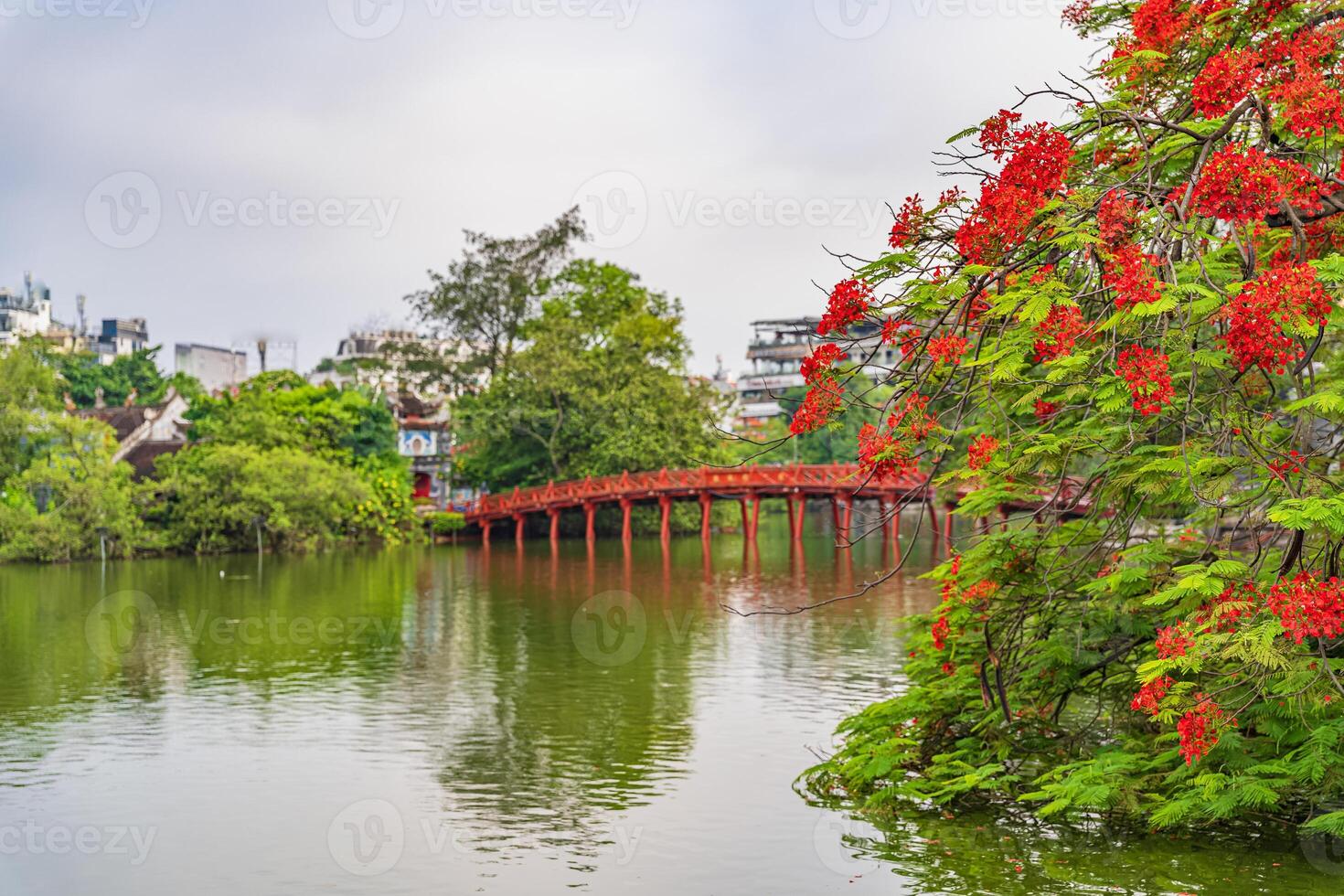 Hoan Kiem lake or Sword lake, Ho Guom in Hanoi, Vietnam with Turtle Tower, on clear day with blue sky and white clouds photo