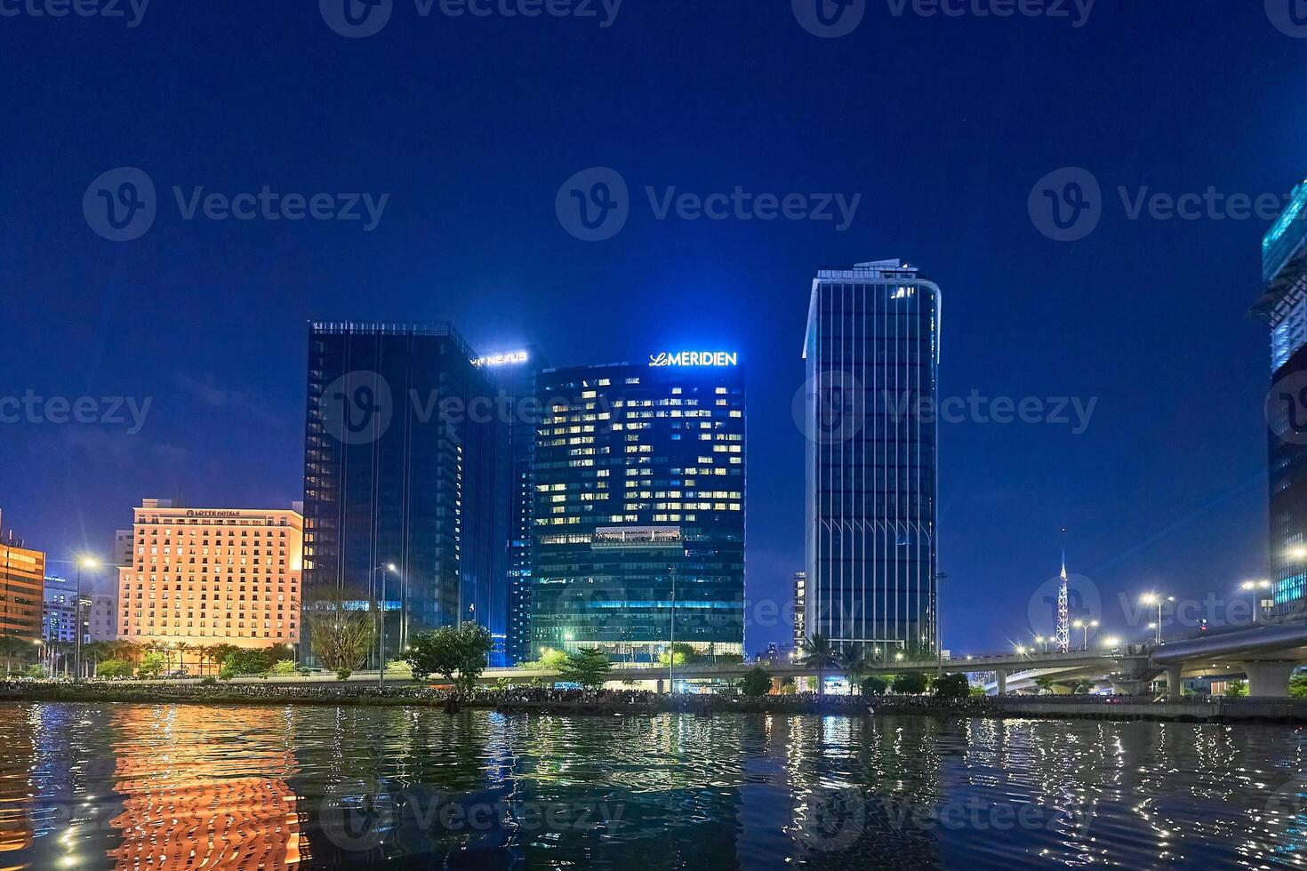 Hochiminh city, Jan 1, 2024 Ho Chi Minh City skyline and the Saigon River. Amazing colorful night view of skyscraper and other modern buildings at downtown. Travel concept photo