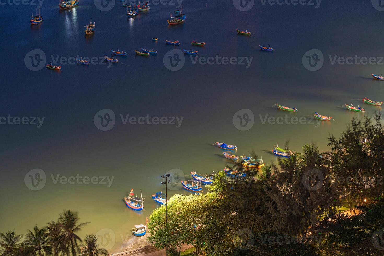 Top view with beautiful sunset and boats. Panoramic view of Vung Tau coast from above with waves, beach, streets, coconut trees and Tao Phung mountain in Vietnam photo