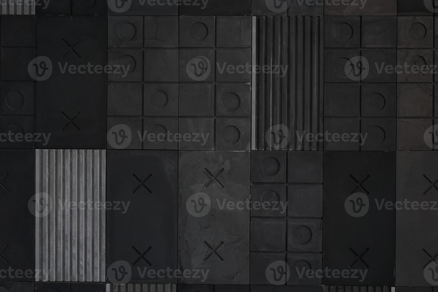 Textured gray and black geometric background made of concrete, paste with stripes, squares, circles, crosses, tic-tac-toe, copy space. Concept of abstract modern wall design with bulky convex elements photo