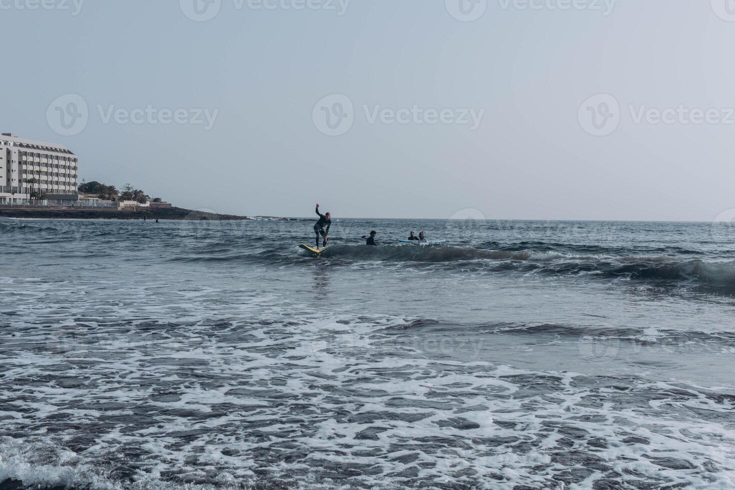young guy surfers going for surfing in the ocean. photo