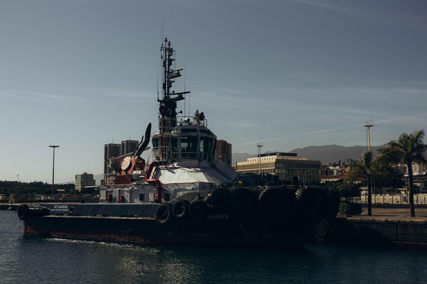Canary Islands, Tenerife-December 19,2023. Tugboat after mooring operation in port of Santa Cruz de Tenerife photo