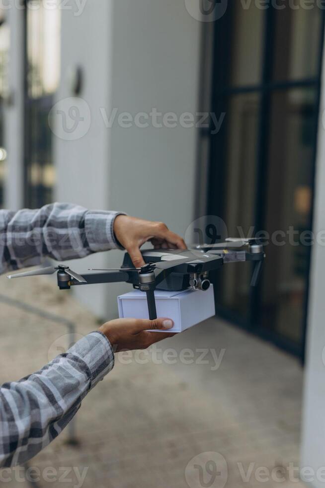 Fast and safe delivery. A drone delivers a gift to a girl, contactless delivery photo