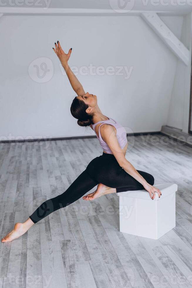 Sporty flexible girl doing stretching exercise photo