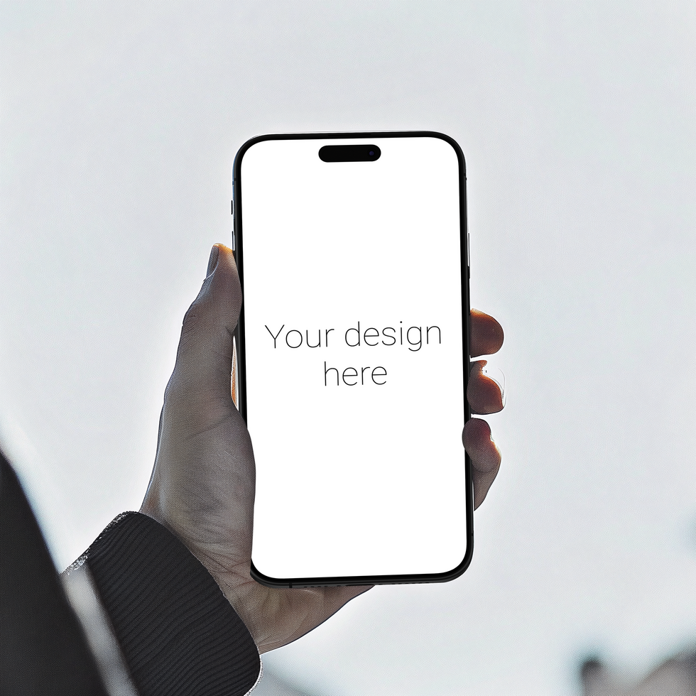 Mockup of black smartphone similar to iphone in persons hand against the gray wall psd