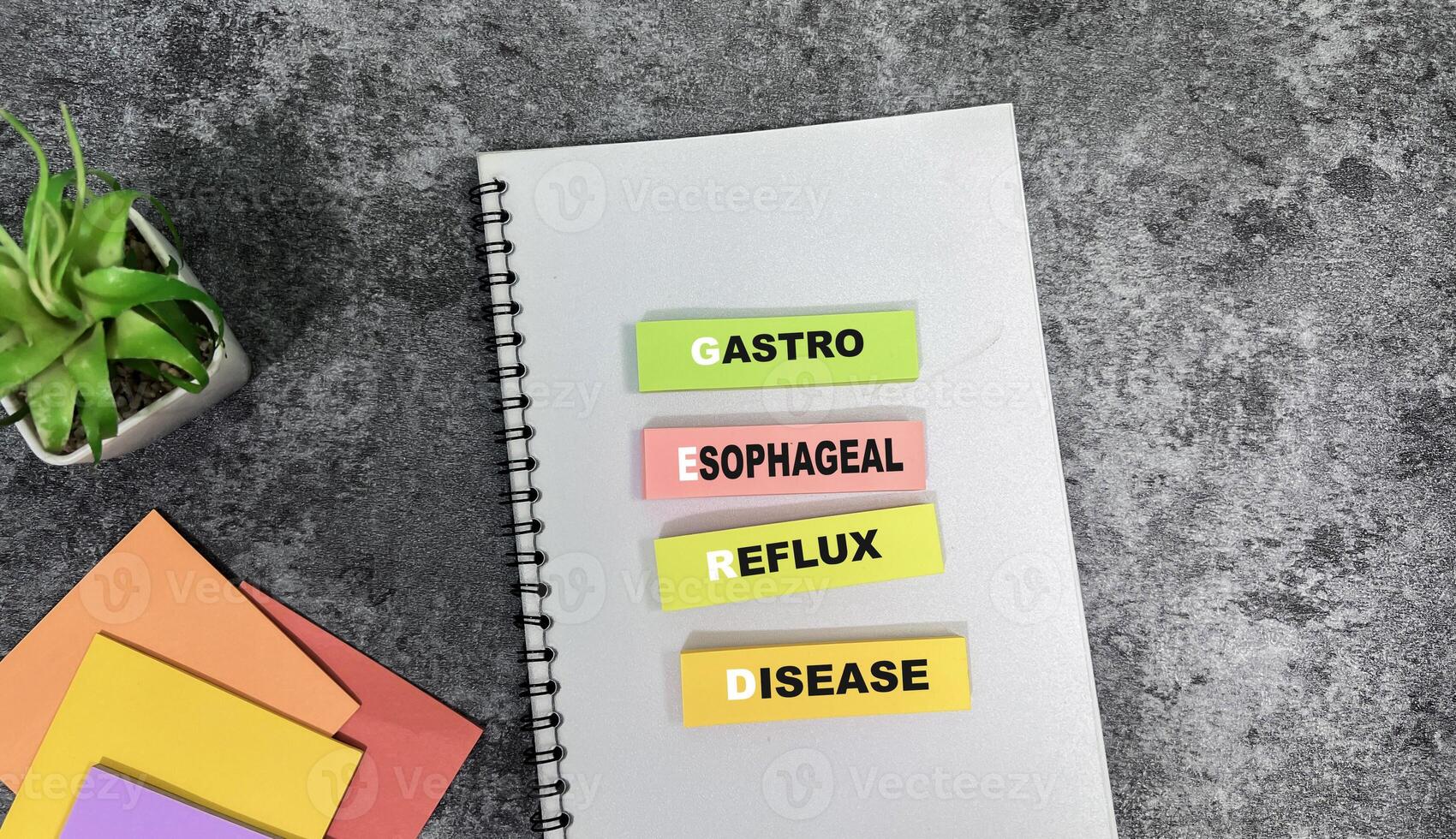 Concept of GERD - Gastro Esophageal Reflux Disease write on sticky notes isolated on Wooden Table. photo