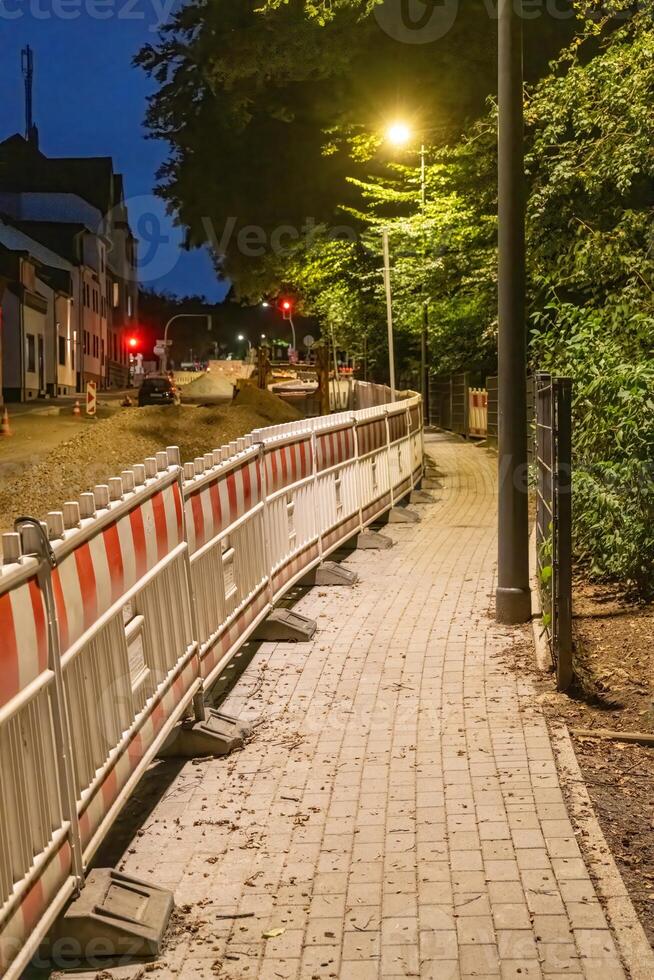 Roadworks with barriers and warning lights at night photo