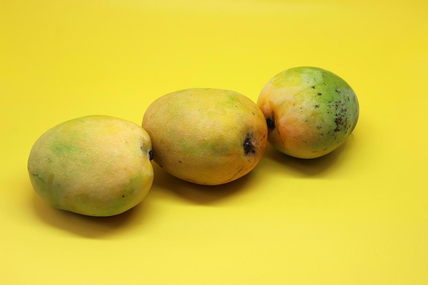 Mango Fruits on yellow background, Gedong Gincu Mango photo