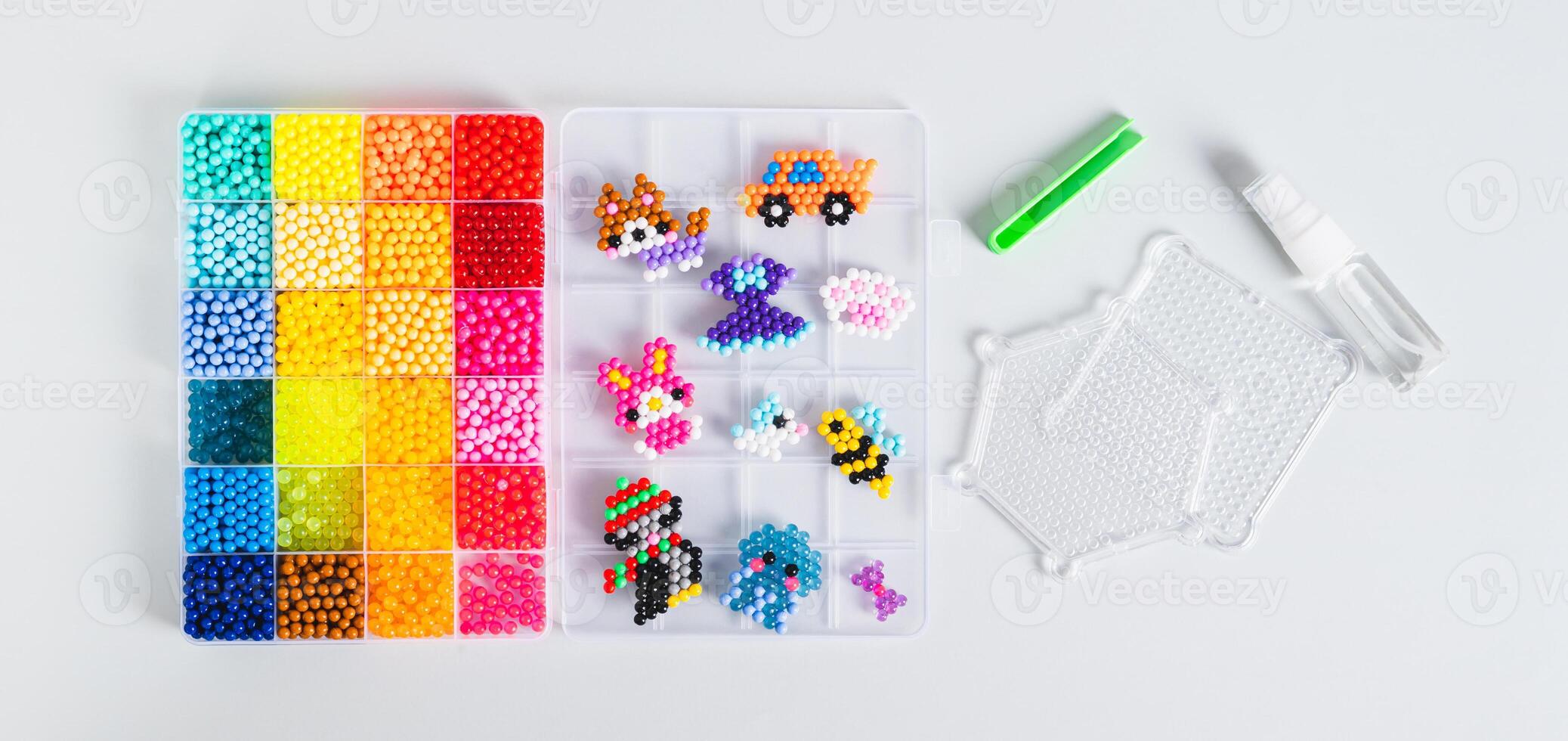 A box with aqua beads and tools for creating a decor top view web banner photo