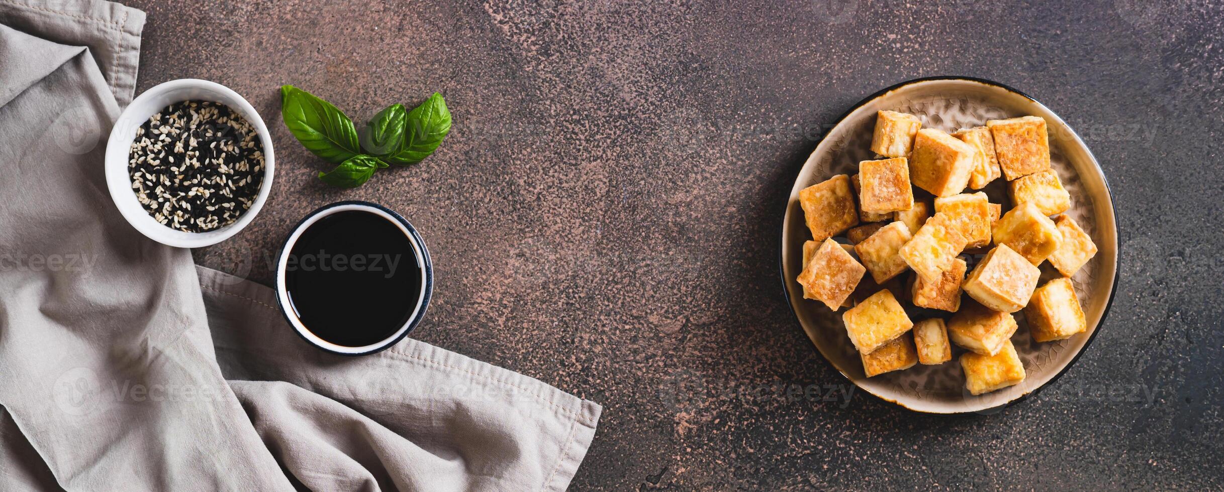 Japanese fried soybean tofu cheese on plate on table top view web banner photo