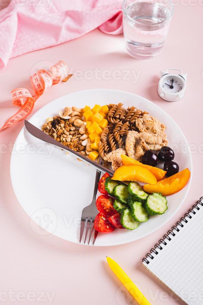 Set of healthy food for individual meal plan on plate on table vertical view photo