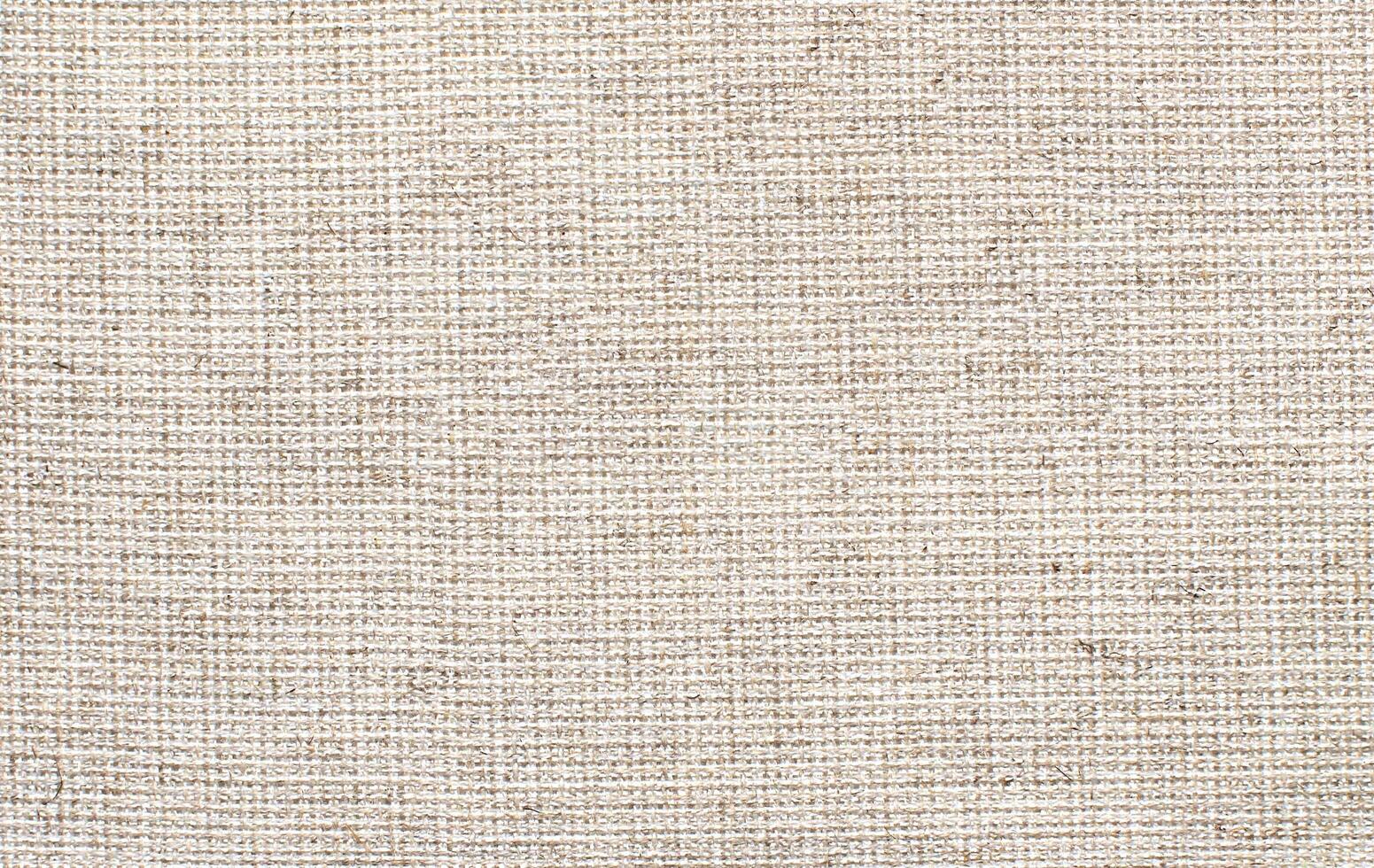 Natural Linen Material Textile Canvas Fabric Texture Background Close-up Detail of Fabric Natural Color Hemp Material Pattern Design Wallpaper. Can be Used as Background or For Graphic Design photo