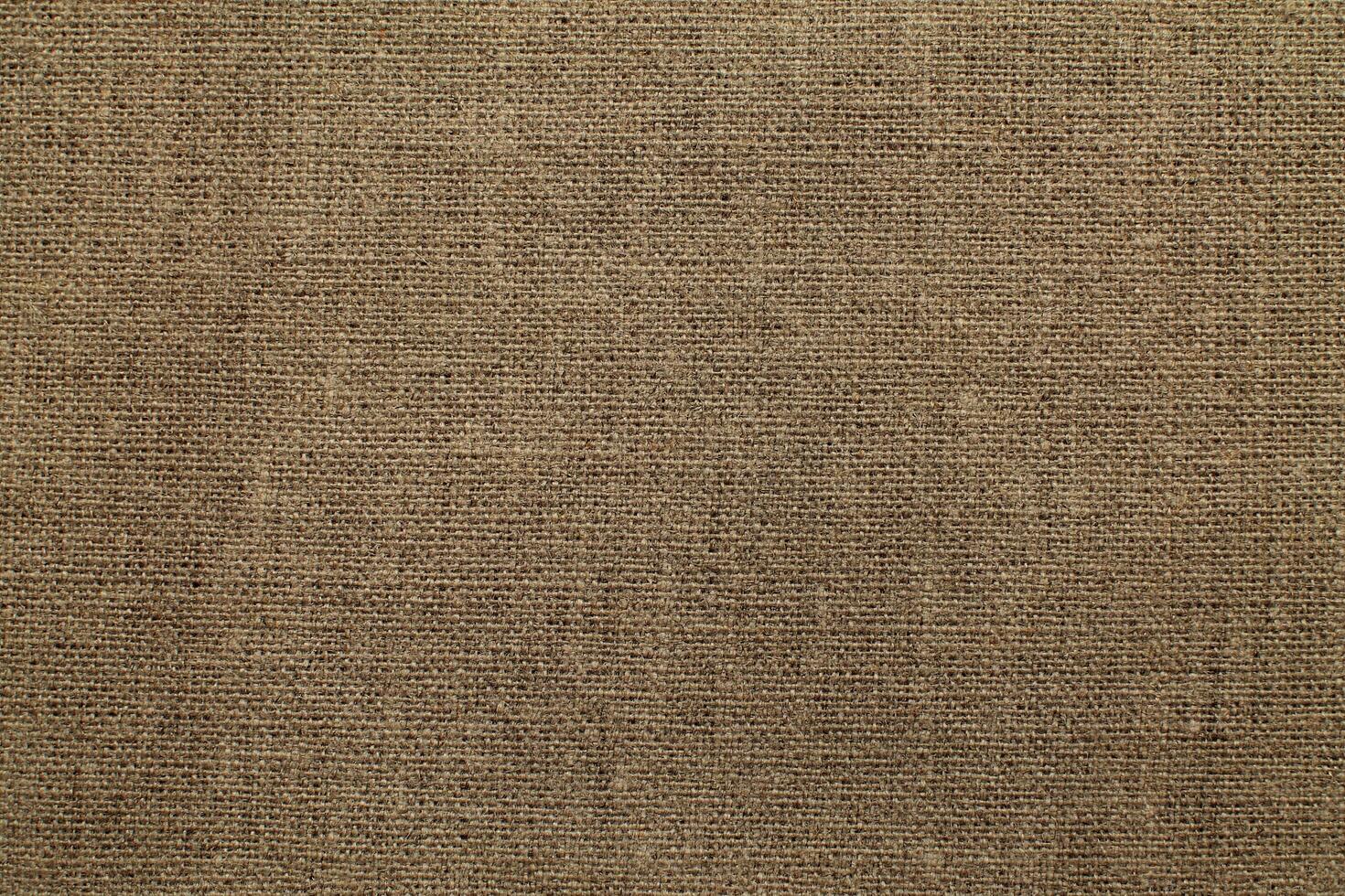 Natural Linen Material Textile Canvas Fabric Texture Background Close-up Detail of Fabric Natural Color Hemp Material Pattern Design Wallpaper. Can be Used as Background or For Graphic Design photo