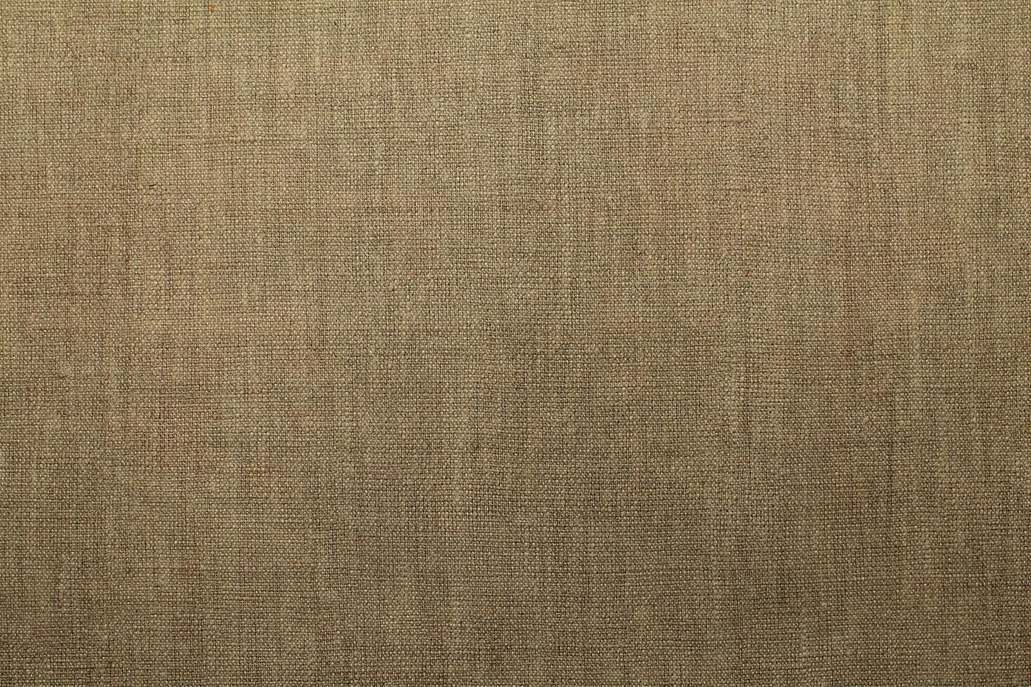 Natural Linen Material Textile Canvas Fabric Texture Background Close-up Detail of Fabric Natural Color Hemp Material Pattern Design Wallpaper. Can be Used as Background or For Graphic Design photo