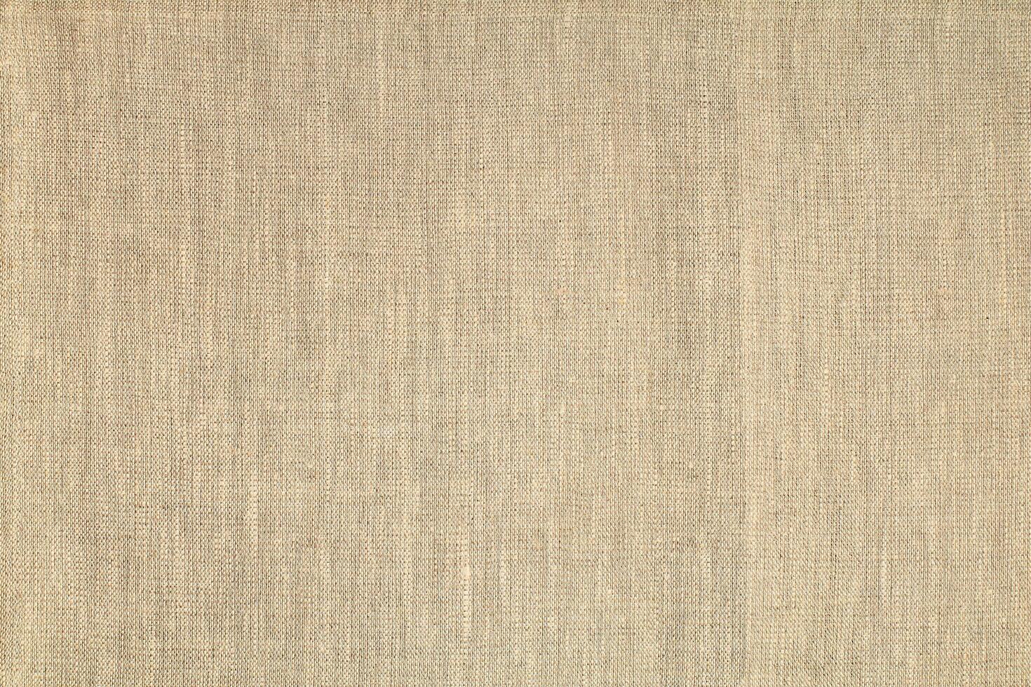 Natural Linen Material Textile Canvas Fabric Texture Background Close-up Detail of Fabric Natural Color Hemp Material Pattern Design Wallpaper. Can be Used as Background or For Graphic Design photo