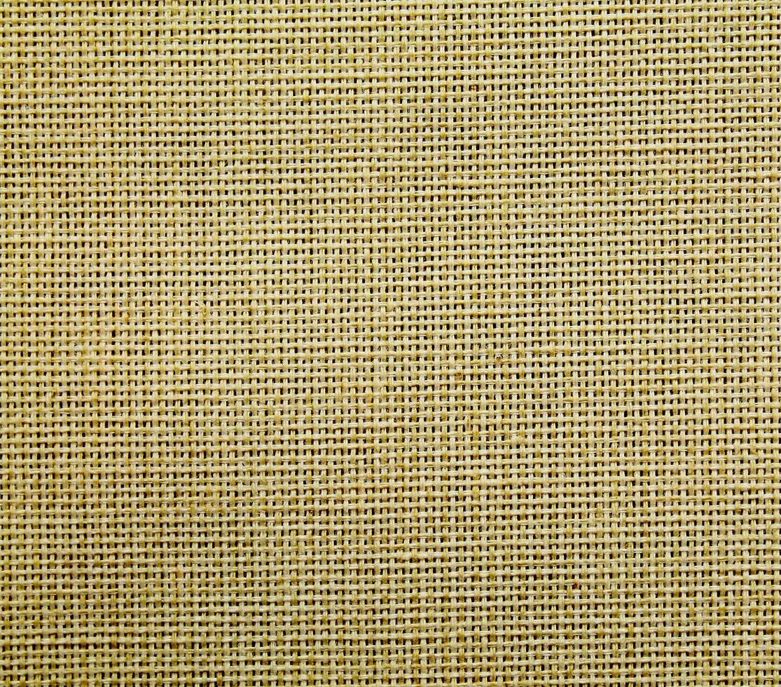Natural Linen Material Textile Canvas Fabric Texture Background Close-up Detail of Fabric Natural Color Hemp Material Pattern Design Wallpaper. Can be Used as Background or For Graphic Design photo