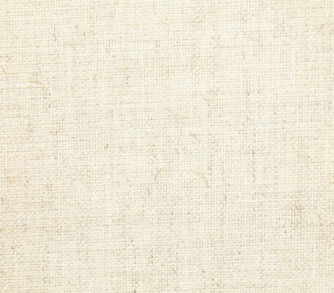 Natural Linen Material Textile Canvas Fabric Texture Background Close-up Detail of Fabric Natural Color Hemp Material Pattern Design Wallpaper. Can be Used as Background or For Graphic Design photo