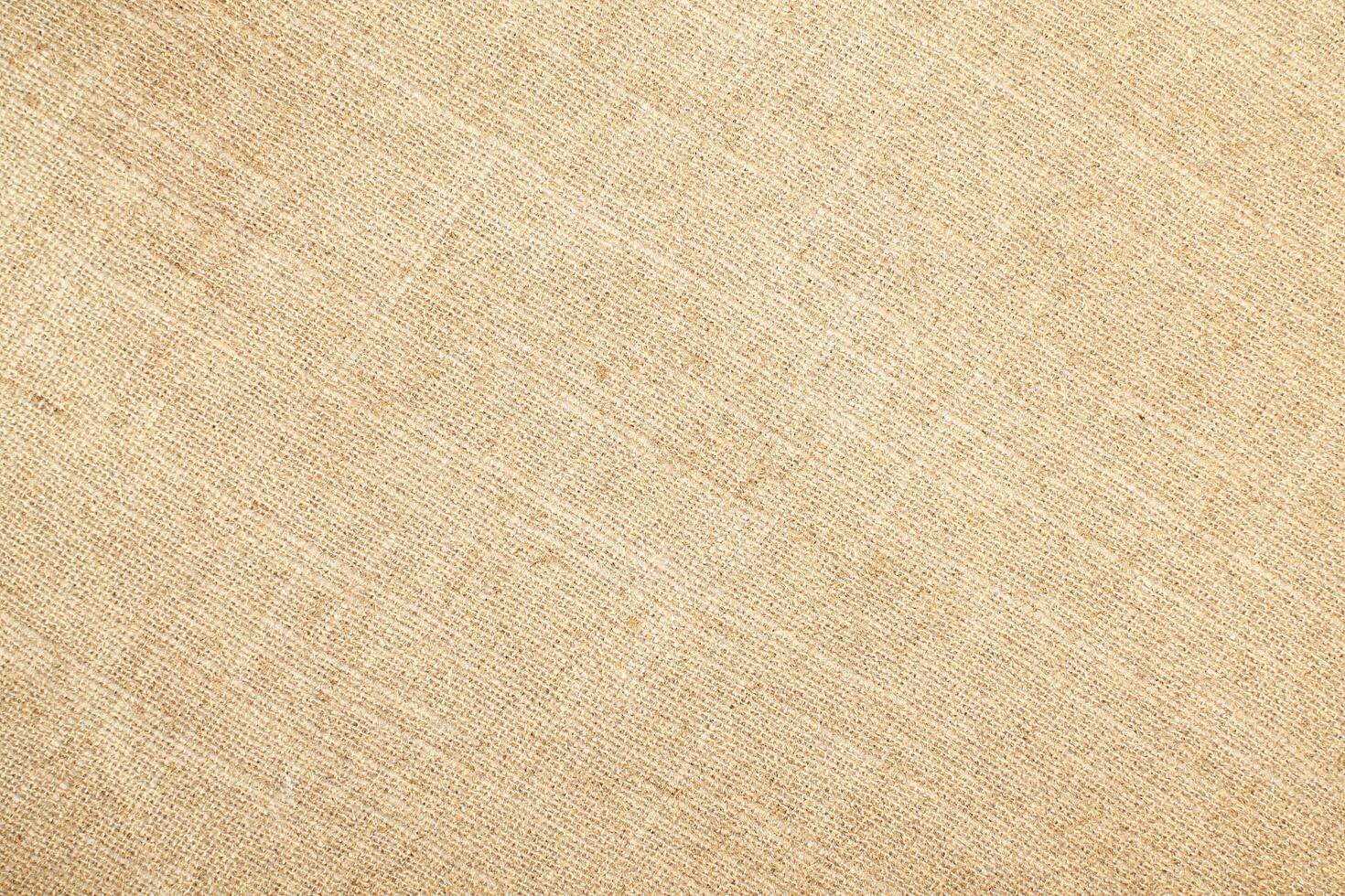 Natural Linen Material Textile Canvas Fabric Texture Background Close-up Detail of Fabric Natural Color Hemp Material Pattern Design Wallpaper. Can be Used as Background or For Graphic Design photo