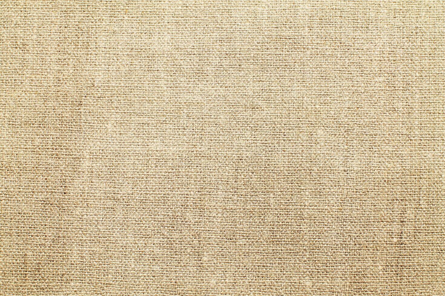 Natural Linen Material Textile Canvas Fabric Texture Background Close-up Detail of Fabric Natural Color Hemp Material Pattern Design Wallpaper. Can be Used as Background or For Graphic Design photo