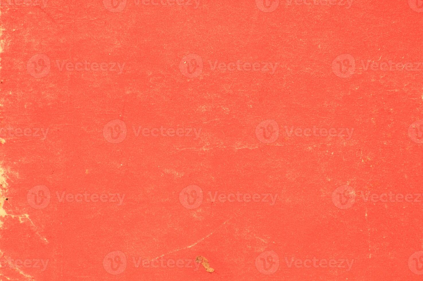 An old red book with a hole in the middle photo