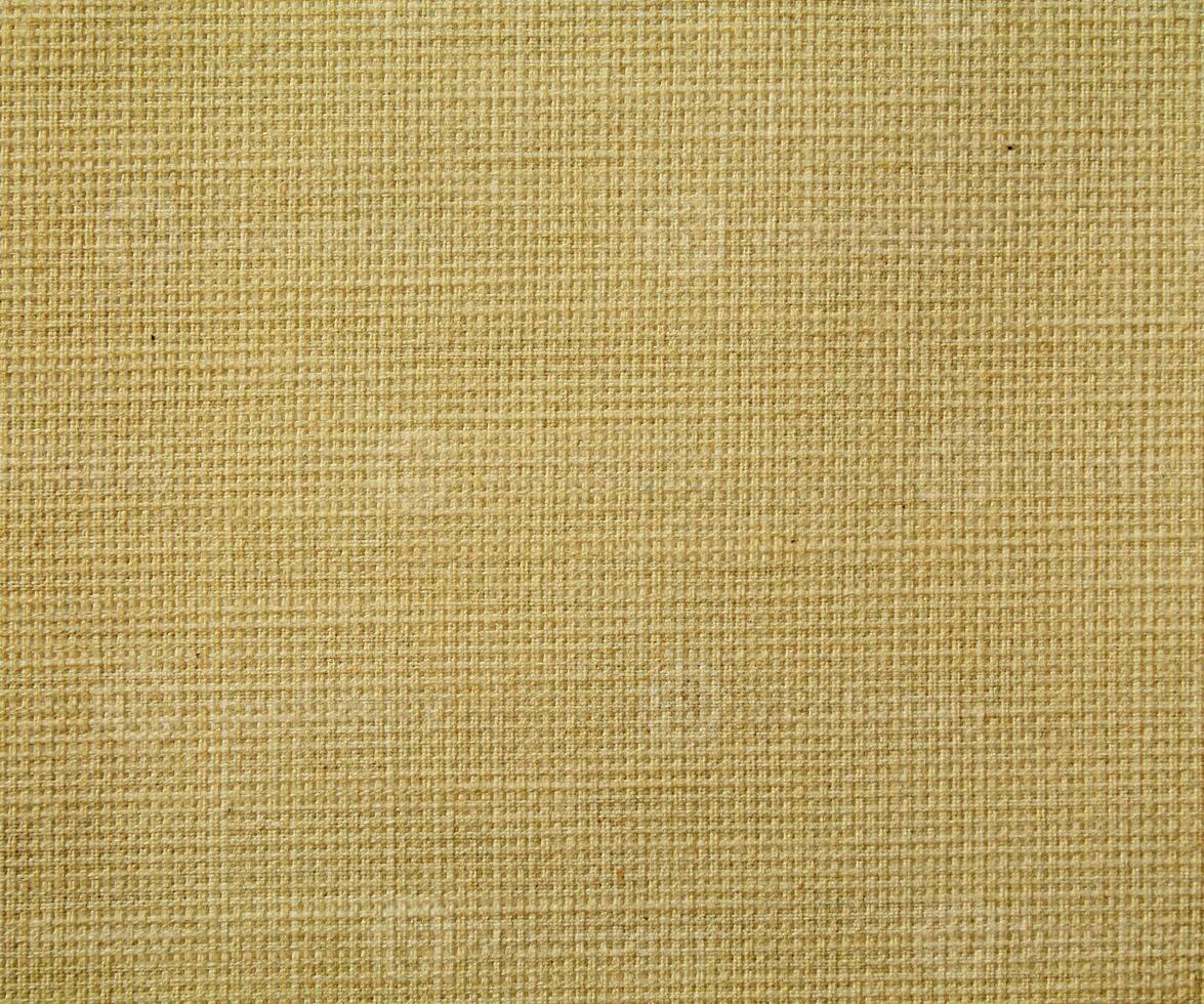 Natural Linen Material Textile Canvas Fabric Texture Background Close-up Detail of Fabric Natural Color Hemp Material Pattern Design Wallpaper. Can be Used as Background or For Graphic Design photo