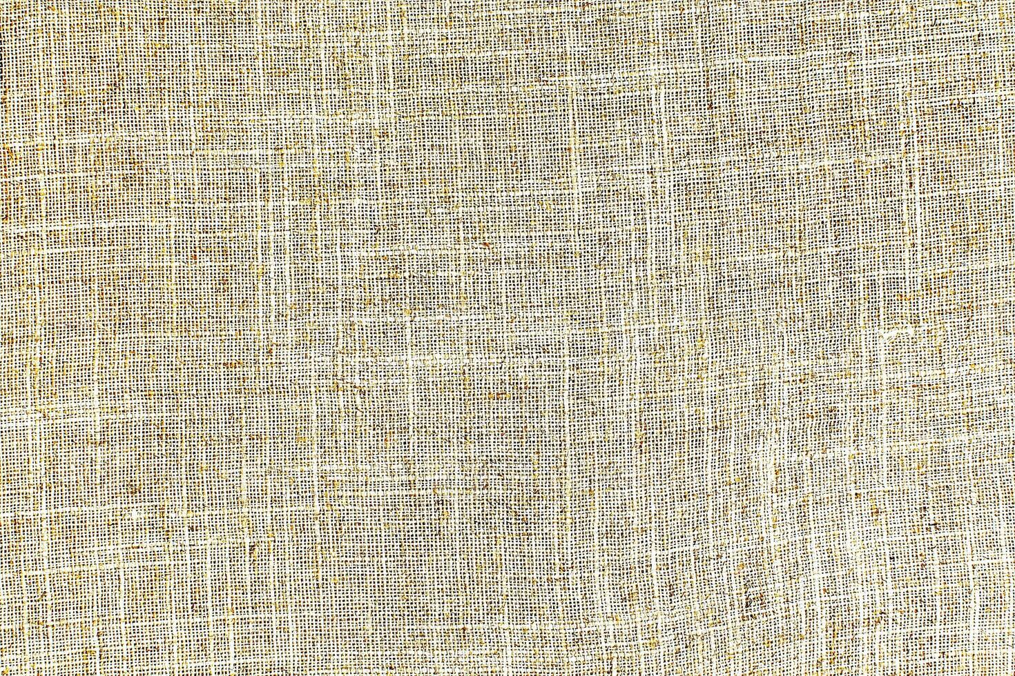 Natural Linen Material Textile Canvas Fabric Texture Background Close-up Detail of Fabric Natural Color Hemp Material Pattern Design Wallpaper. Can be Used as Background or For Graphic Design photo