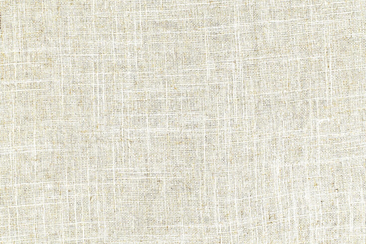 Natural Linen Material Textile Canvas Fabric Texture Background Close-up Detail of Fabric Natural Color Hemp Material Pattern Design Wallpaper. Can be Used as Background or For Graphic Design photo