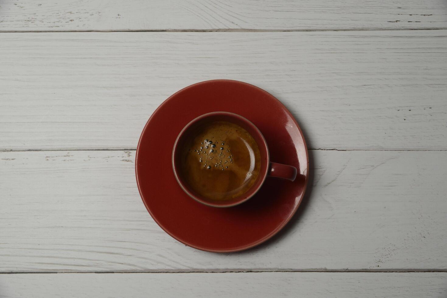 Hot espresso in a red glass photo