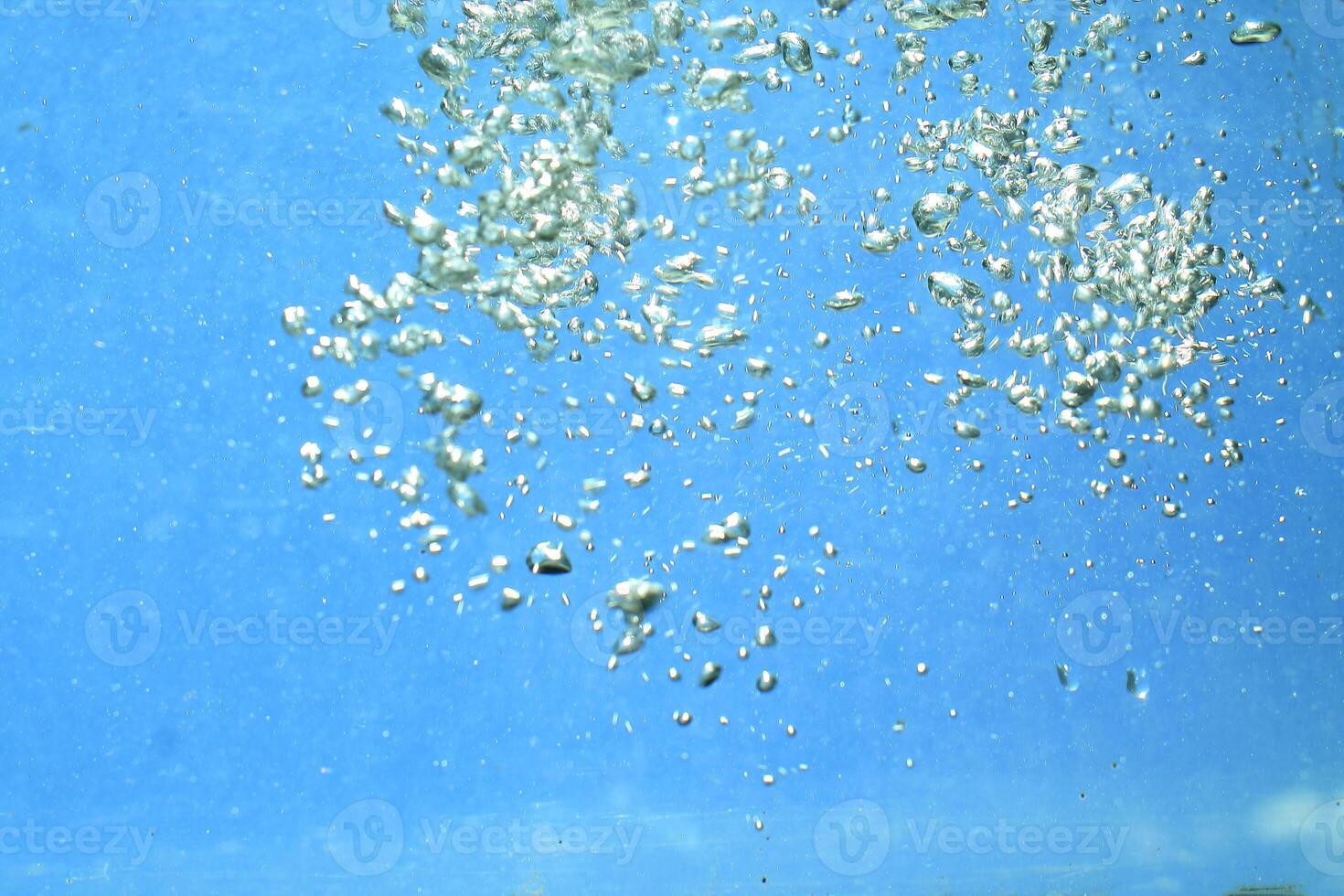 fresh water with underwater bubbles texture on a blue background close-up abstract liquid bubbles aqua design wallpaper photo