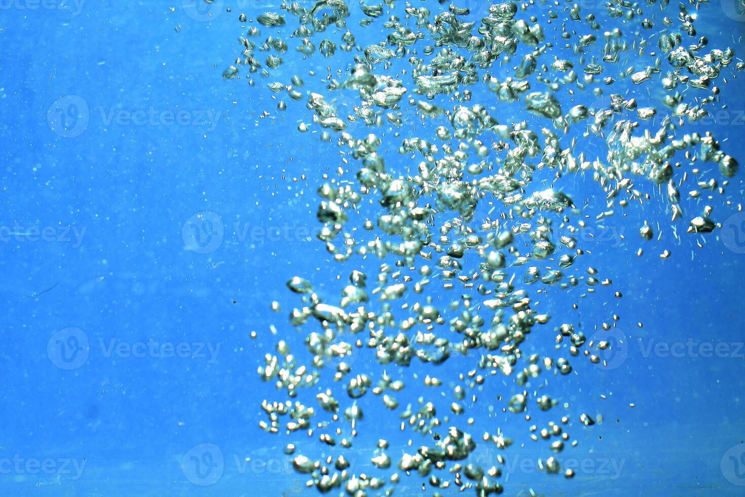 fresh water with underwater bubbles texture on a blue background close-up abstract liquid bubbles aqua design wallpaper photo