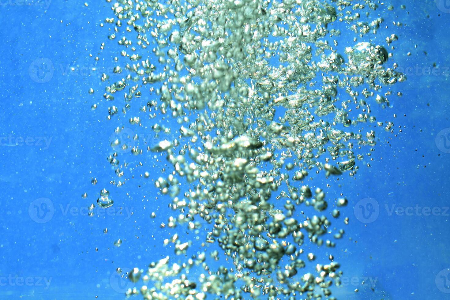 fresh water with underwater bubbles texture on a blue background close-up abstract liquid bubbles aqua design wallpaper photo